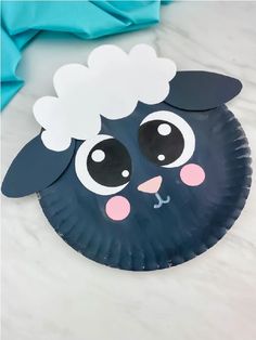 a paper plate with a black sheep on it