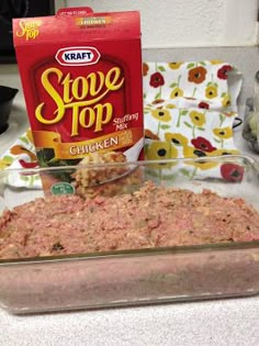 a glass casserole dish filled with ground meat next to a packet of stove top chicken seasoning