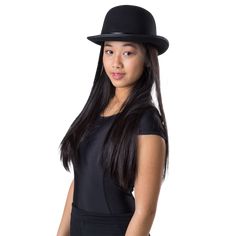 Kids Black Derby Bowler Hat Features a black brim, adorned with a shiny band One size fits most kids Whether it’s a Gatsby soirée, a vintage-themed bash, or a random Wednesday when you decide life needs more flair, this hat has your back. Adjust it just so, and suddenly you’re channeling a blend of Humphrey Bogart and a jazz-loving cat. So go ahead, my fellow style maven. Tilt that hat, flash a mysterious smile, and let the intrigue begin. Bowler Hat Women Conner Hats, Black Bowler Hat Women, Black Bowler Hat, Black Felt Hat, Indian Dress Up, America Dress, Costumes Wigs, British Gentleman, Zombie Girl