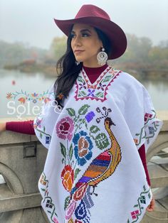 This Beautiful Hand Embroidered Poncho is perfect for keeping you warm and stylish at the same time. It has gorgeous hand embroidered details in both the front and back of the poncho. This poncho is handmade by Mexican Artisans and is completely one of a kind. Note: This poncho has open sides and comes in one size which is ideal for sizes, Small, Medium, Large, Extra Large, 2x, 3x. Traditional White Shawl For Festival, White Shawl Poncho For Festival, Traditional White Shawl One Size, White Handmade Bohemian Poncho, Traditional White Poncho One Size, White One-size Traditional Poncho, Traditional Mexican Dress, Mexican Hat, Embroidered Belt