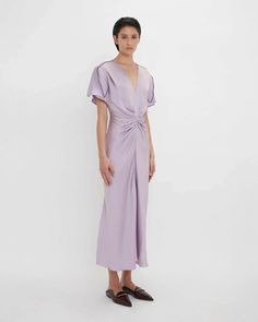 FINAL SALE The Gathered V-Neck Midi Dress in Petunia by Victoria Beckham is a midi length, v-neck dress featuring waist defining pleats and draped short sleeves with exposed, contrast seams. Invisible zip and hook and eye closure at back 100% Viscose Made in Portugal #1324WDR005195A Dress Showroom, Gold Clothes, Rose Gold Clothes, Curved Neckline, Elegant Midi Dresses, Talking Points, Exposed Seams, V Neck Midi Dress, Victoria Dress