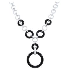 A unique necklace featuring over 3 carats of VS quality round cut diamonds set in 18K white gold. Fine jet black onyx carved into perfect circles are linked together with the gold diamond studded links. A clean sophisticated look. Length: 11 inches Gold Geometric Necklace, Stud Necklace, Necklaces Black, Gold Circle Necklace, Gold Diamond Studs, Small Necklace, Black Onyx Necklace, Necklaces Gold, Studded Necklace