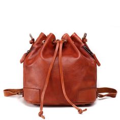 The Tulip Leather Vintage Bucket Bag is made of high-quality, full-grain leather, and its authentic vintage flair makes it a beautiful yet functional tote option for travel and every-day use. Boasting a large carry volume and two color options, the Tulip Leather Vintage Bucket Bag allows for quick and easy access to your belongings through two side-zip compartments. This unique bucket bag combines fashion and function to suit all of your work, travel, school, and other carry needs. Made of 100% Vintage Bucket, Tassels Fashion, Dark Brown Color, Women Bags Fashion, Genuine Leather Handbag, Leather Bucket Bag, Travel School, Leather Bucket, Crazy Horse