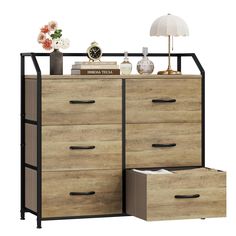 an image of a dresser with drawers in the middle and a lamp next to it