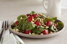 strawberry spinach salad with balsamic vanilla vinaigrete on a white plate