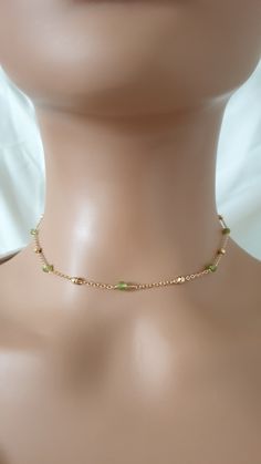 The necklace is made with gold plated chain, natural peridot beads (3 mm) and gold plated brass lobster clasp.  The length of the extension is approximately 2 inches.  Please contact me in case you have any questions. Please note: store your jewellery individually to keep them from scratching each other. Avoid contact with perfume, body lotions, hairspray or any other chemical. Gold Crystal Necklaces With Delicate Chain And Round Beads, Gold Beaded Minimalist Crystal Necklace, Dainty Green Beaded Chain Jewelry, Green 14k Gold Filled Jewelry With Delicate Chain, Minimalist Gold Beaded Crystal Necklace, Delicate Green 14k Gold-filled Jewelry, Green Dainty Jewelry With Tiny Beads, Dainty Gold Crystal Necklace With Tiny Beads, Dainty Green Jewelry With Tiny Beads