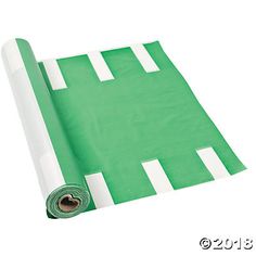 a roll of green paper sitting on top of a white flooring mat with a hole in the middle