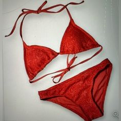 Elevate Your Beach Look With This Stunning Vincento Camuto Bikini In A Beautiful Red Hue. The Two-Piece Swimsuit Features A Triangle Top With Spaghetti Straps And A Hipster Bottom Style. The Bikini Is Made Of Spandex And 100% Polyester Material, Making It Comfortable And Machine Washable. The Garment Care Is Easy, And The Bikini Is Perfect For A Day At The Beach Or Pool. The Bohemian Theme Is Accentuated By The Crochet Detailing, Making It A Stylish Addition To Your Swimwear Collection. This Bik Red Fitted Swimwear For Holiday, Fitted Red Swimwear For Holiday, Red Fitted Holiday Swimwear, Lined Red Swimwear For Beach Season, Red Lined Swimwear For Beach Season, Bohemian Theme, Crochet Triangle, The Bohemian, Triangle Top