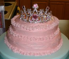 a pink cake with a tiara on top