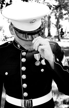 a man in uniform is holding his hand to his face