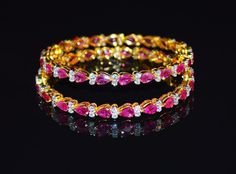 "1 solid 18k gold 10.35cts diamond and ruby bangle f-g color and vs clarity untreated natural diamonds and untreated natural pinkish red rubies. extremely high end - top quality bangle (i have 2 bangles, but this listing is of one bangle. please contact me if you are interested in both bangles) here is the description of one bangle: this is a custom made top quality ruby and diamond bangle. the bangle is loaded with 1.71cts of round brilliant cut diamonds and 22 pear cut natural red rubies total Ruby Bangles, Stackable Bangles, Stone Bangle, Bangles Jewelry Designs, Gold Top, Diamond Bangle, Bangles Jewelry, Pink Stone, Natural Red