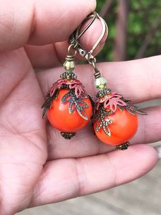 Orange Boho Earrings, Bohemian Earrings, Autumn colors, Fall Dangle Earrings, Leaves Earrings, Handmade Jewelry, Gift Ideas for her, women Hello, This is a handmade item made by myself. I love these,, they are very unique and beautiful. They make a perfect handmade gift for any occasion. Color : Orange Finish : Acrylic bead, hand-painted metal Size : Approximately 1.75 inches with the lever back ear wires included. Ear wires : antiqued bronze lever back ear wires The earrings will arrive in a co Orange Bohemian Jewelry For Pierced Ears, Bohemian Orange Drop Earrings, Bohemian Earrings With Lever Back, Orange Pierced Metal Earrings, Orange Metal Pierced Earrings, Orange Round Bohemian Earrings, Bohemian Orange Round Earrings, Orange Metal Drop Earrings, Leaves Earrings