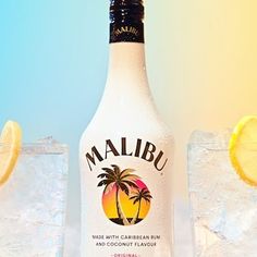 a bottle of malbu next to some lemon wedges