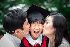 a woman kissing a man while he kisses his son