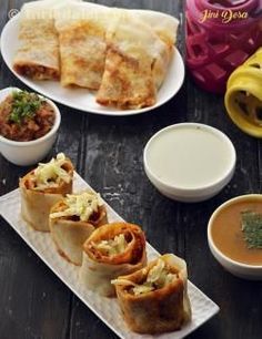 some food is sitting on a table with bowls and sauces next to the plates