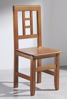 a wooden chair sitting on top of a white floor