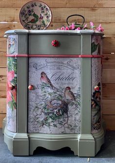 a painted cabinet with birds and flowers on it