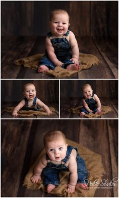 a baby sitting on top of a wooden floor in blue overalls and smiling at the camera