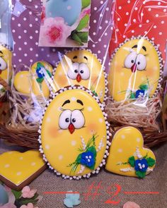 some decorated cookies in the shape of birds and hearts are sitting next to each other