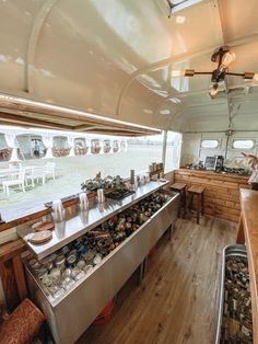 the inside of a camper with lots of food on the counter and in the back