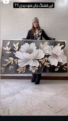 a woman sitting on top of a bench with flowers painted on the back of it