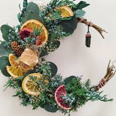 a wreath made out of oranges and greenery