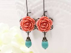 "These are beautiful and sweet romantic coral rose and turquoise earrings. They feature lovely coral rose resins on top of brass floral filigrees. The genuine Swarovski turquoise pearls in lace bead caps are dangling freely in movement. They are hanging underneath kidney brass ear wires. The earrings measure about 74mm (2.9 inches) from the top of the ear wire to the bottom of the pearl. They are perfect for occasions, a wonderful idea for gift giving and as a little treat for yourself. Your ear Handmade Coral Earrings For Wedding, Coral Wedding Earrings, Coral Rose, Dangle Earrings Boho, Vintage Style Jewellery, Long Dangle Earrings, Leverback Earrings, Earrings Pink, Floral Jewellery