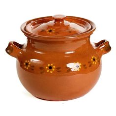 a brown ceramic pot with flowers on the rim and lid, sitting on a white surface