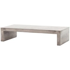 a concrete coffee table sitting on top of a white floor