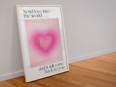 there is a poster on the floor in front of a wall that says, send love into the world and it will come back to you