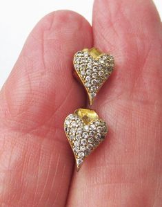 These very pretty pre-owned 14K gold-plated sterling silver pave' cubic zirconia pierced stud earrings  measure approximately 3/8" x 1/4" x 1/8" with an elongated modern heart shape.  They are in mint, like-new condition with no wear or damage.    FREE SHIPPING within the USA and they will arrive gift boxed.    1113 Gold Heart Earrings With Cubic Zirconia For Formal Events, Gold Heart Earrings With Cubic Zirconia For Formal Occasions, Formal Gold Heart Earrings With Cubic Zirconia, Formal Gold Heart Cubic Zirconia Earrings, Gold Cubic Zirconia Pierced Heart Earrings, Gold Heart Earrings With Cubic Zirconia, Sparkling Gold Earrings For Valentine's Day, Gold Heart Shaped Diamond Earrings In Sterling Silver, Gold Heart Cut Sterling Silver Diamond Earrings