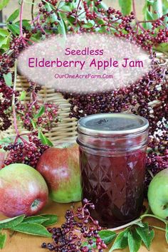 a jar of elderberry apple jam surrounded by apples and berries