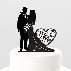 a wedding cake topper that says just married with a bride and groom on it