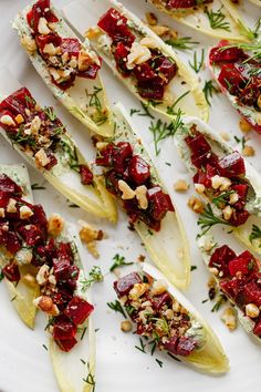 some food is laying out on a white plate and garnished with chopped nuts