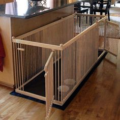 a dog gate in the middle of a kitchen