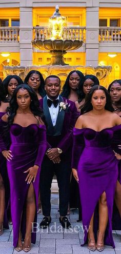 a group of women in purple dresses standing next to each other with one man wearing a tuxedo