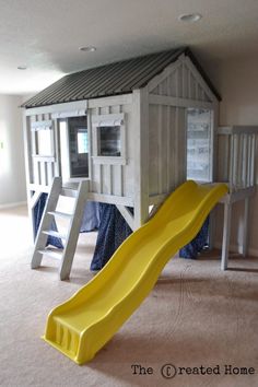 a yellow slide is in the middle of a play room with bunk beds and ladders