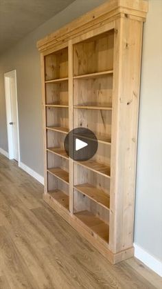 an empty room with wooden shelves and hard wood flooring