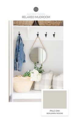 a white bench with a mirror, coat rack and flowers on it's shelf