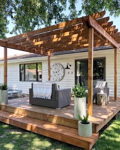 a patio with an attached pergolan and couches on the outside deck area