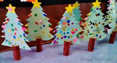 paper christmas trees are lined up on the table