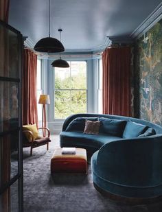 a living room filled with furniture and walls covered in wallpaper