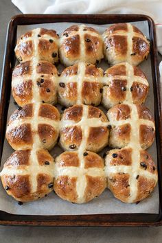 freshly baked hot cross buns on a baking sheet