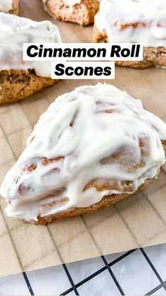 frosted pastries sitting on top of a cooling rack