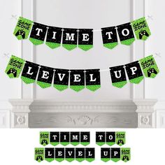 the time to level up banner is hanging from a mantle with green and black decorations