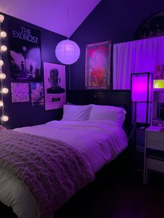 a bedroom with purple lighting and pictures on the wall