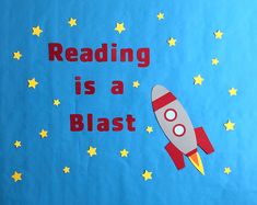 a bulletin board with the words reading is a blast written in red and yellow stars