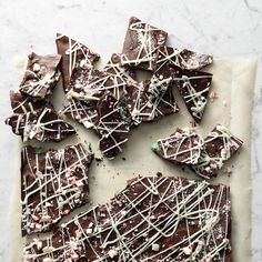 there are many pieces of chocolate that have been drizzled with white icing