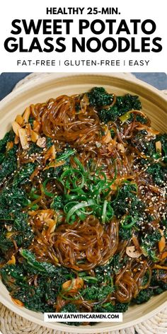 a bowl filled with noodles and vegetables on top of a table