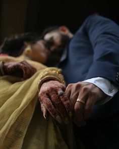 the bride and groom hold hands as they lay on their wedding day in front of each other